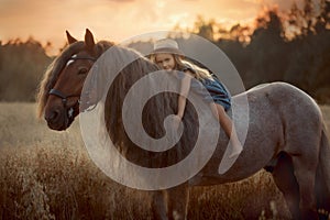 Little girl with palomino miniature horse in summer day