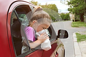 Little girl with paper bag suffering from nausea