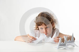 Little girl with paper cranes