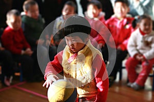 Little girl patting ball