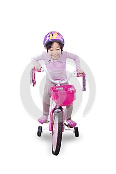 Little girl pedaling bicycle photo