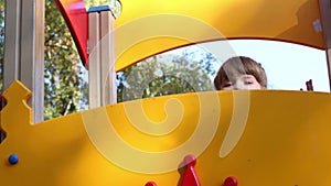 Little girl peeking fun on playground