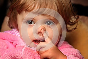 Little girl picking her nose