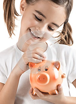 Little girl with a piggy-bank