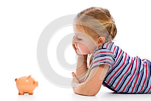 Little girl with piggy bank