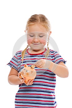 Little girl with piggy bank