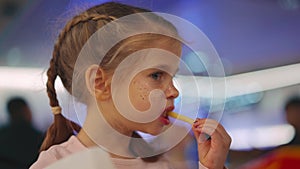 Little girl with pigtails eating fried french fries. Close up portrait caucasian female 5 years eat fast food in a