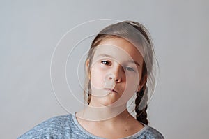 Little girl with pigtails expresses emotions of negative anger and irritation