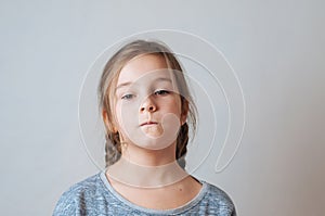 Little girl with pigtails expresses emotions of negative anger and irritation