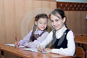 Little girl with pigtails smiling in class