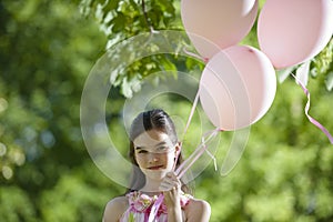 Little girl with pink balllons