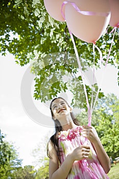 Little girl with pink balllons