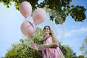 Little girl with pink balllons