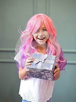 little girl with pink hair holding a gift box. Happy Vanilla Girl. Kawaii vibes. Candy colors design. Marry