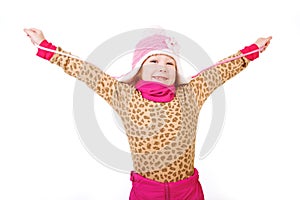 Little girl in a pink hat with arms outstretched