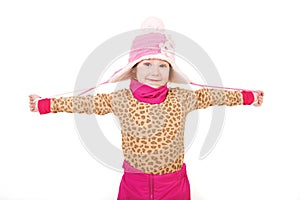 Little girl in a pink hat with arms outstretched