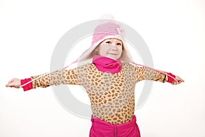 Little girl in a pink hat with arms outstretched