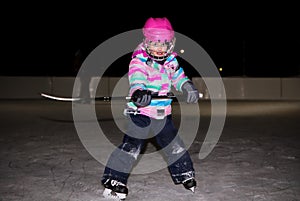 Little girl in pink in hockey gear