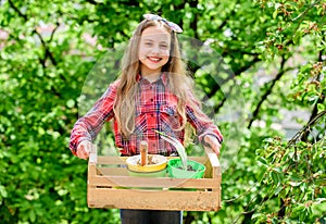 Little girl planting plants. Day at farm. Planting flowers. Plant veggies. Planting season. Popular garden care. Inspect