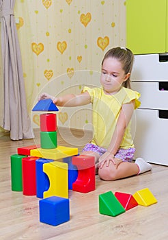 Little girl with plastic cubes