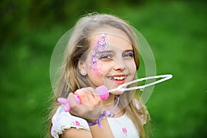 Little girl play with bubble blower