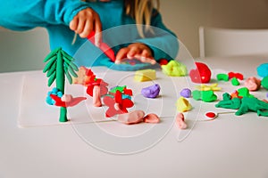 Little girl play with clay molding shapes