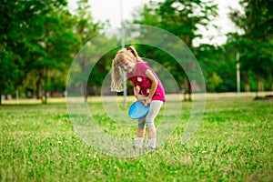 Little girl play with flying disk in motion, playing leisure activity games
