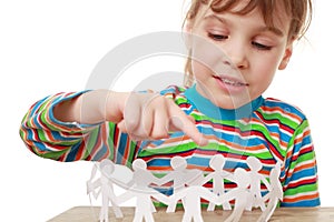 Little girl play with garland of paper creatures