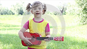 Little girl play guitar