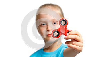 Little girl play with modern finger spinner.