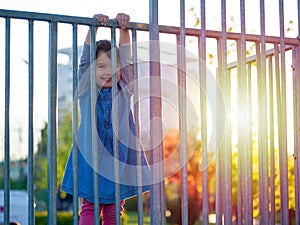 Little girl play on playground at sunset