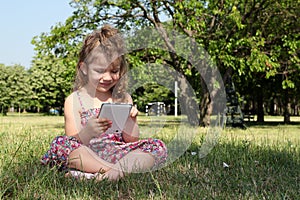 Little girl play with tablet