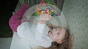 Little girl play with three-dimensional toy puzzle