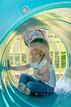 Little girl in play tube