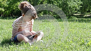 Little girl play video game on tablet