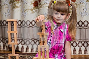 Little girl play with wooden blocks