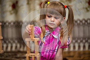 Little girl play with wooden blocks