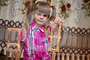 Little girl play with wooden blocks