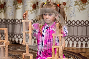 Little girl play with wooden blocks