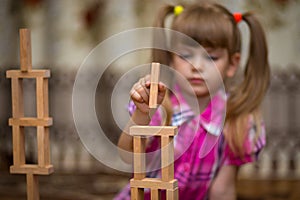 Little girl play with wooden blocks
