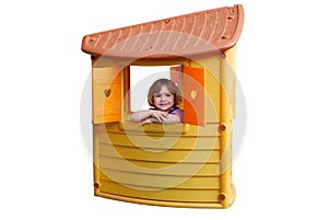 Little girl in playhouse toy