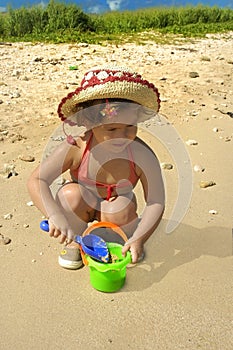 Little girl playin in the sand