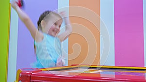 Little girl playing air hockey