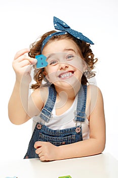 Little girl playing in the alphabet. Shows the letter B.