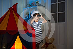 Little girl playing as sailor in living room