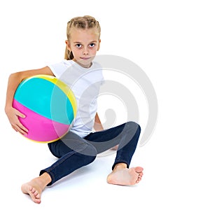 Little girl is playing with a ball