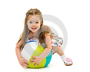 Little girl is playing with a ball