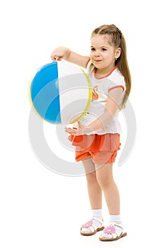 Little girl is playing with a ball