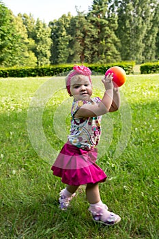 Little girl playing with a ball