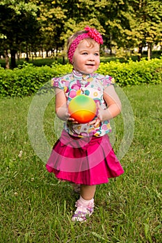 Little girl playing with a ball